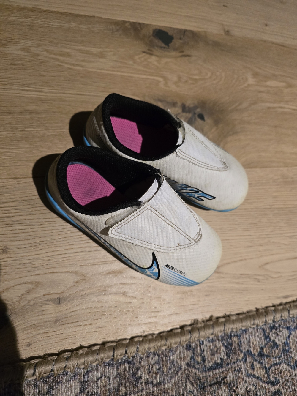 Nike Kids White Slip-On Sneakers with Pink Lining and Blue Accents